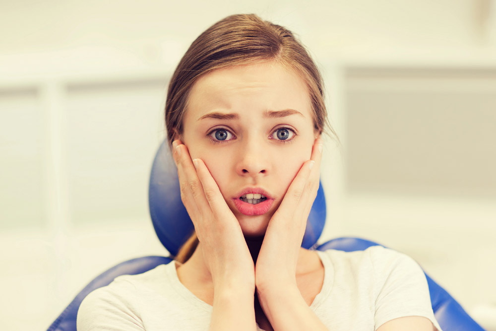 Anxious young woman at orthodontics appointment