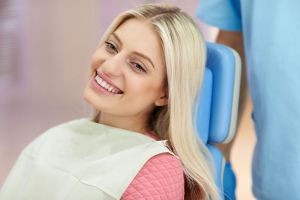 Smiling young woman at orthodontics appointment | Life after braces